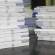 Piles of handout papers lying on a table. Piles of handout papers lying on a table.